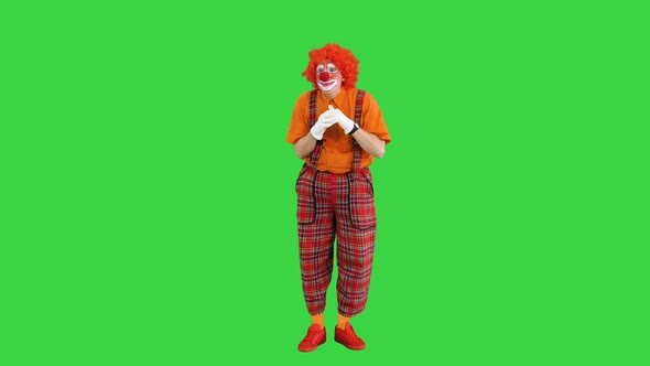 Funny Clown Having Some Hard Thinking and Coming Up with Some Decision on a Green Screen Chroma Key