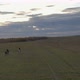 Two Riders Gallop Across the Field. Aerial Shot - VideoHive Item for Sale