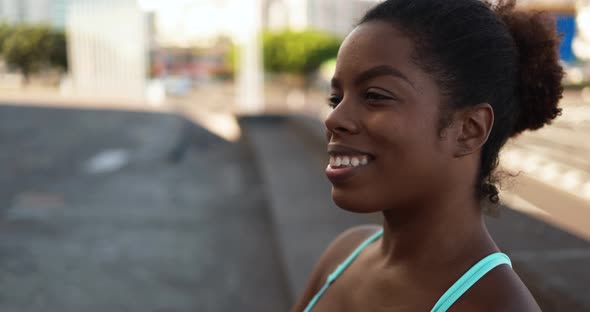 Fit african girl smiling in the city after sport workout