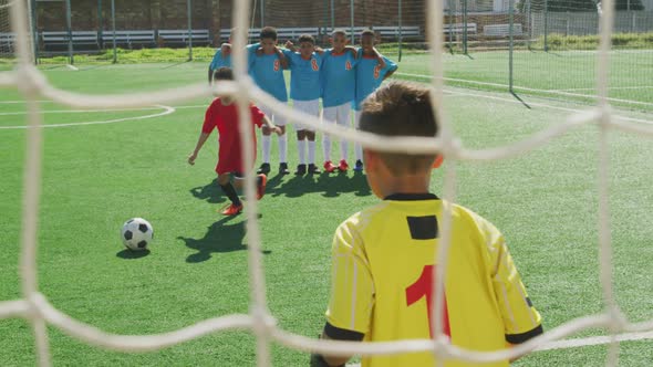 African American kid in red scoring in a sunny day