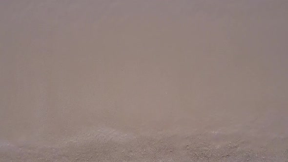 Aerial drone travel of marine shore beach by blue water and sand background