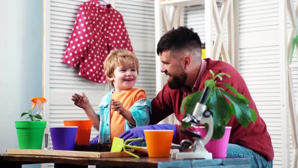 Happy Boy Helping His Dad To Plant in Pots.