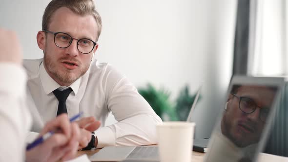 Business Colleague Man Helps Office Worker. Entrepreneur Explain Coaching and Pointing at Laptop