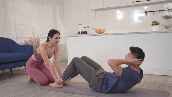 Woman help and support boyfriend to sit up at home