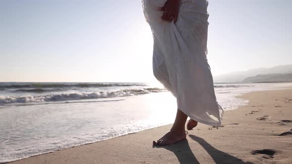 Pregnant Asian woman enjoying walk on the beach