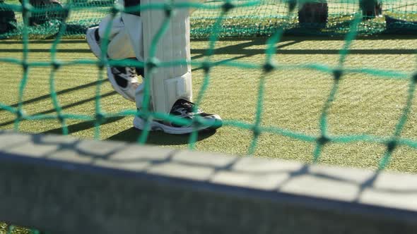 Cricket player walking on the pitch during a practice session