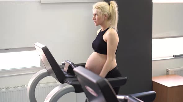 Pregnant Woman Training Treadmill Machine in Gym Cardio Exercises on Running Simulator