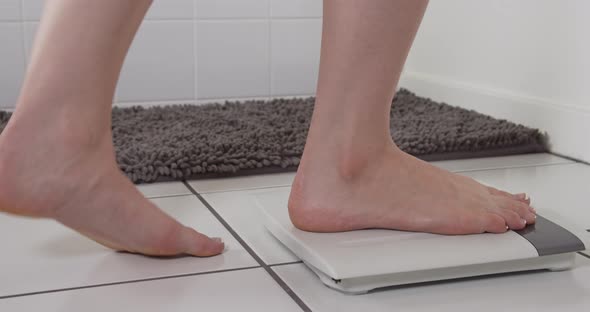 Woman Checking Weight Bathroom Scale