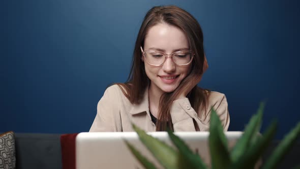 Smiling Young Caucasian Woman Using Laptop Notebook Looking at Screen Typing Message, Happy Lady