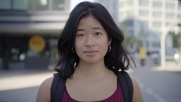 Portrait Serious Asian Woman Looking at Camera Outdoors