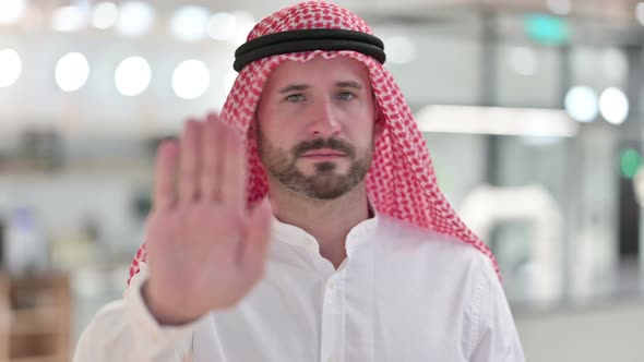 Serious Arab Businessman Showing Stop Sign By Hand 