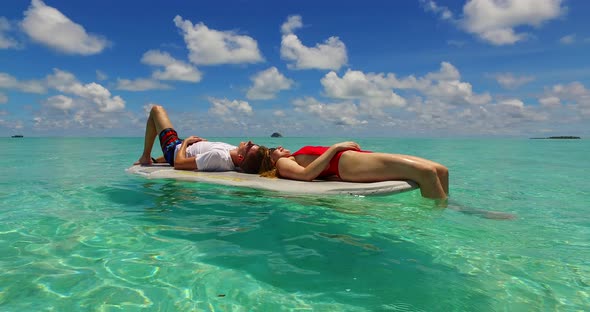 Beautiful boy and girl on romantic honeymoon live the dream on beach on summer white sandy background