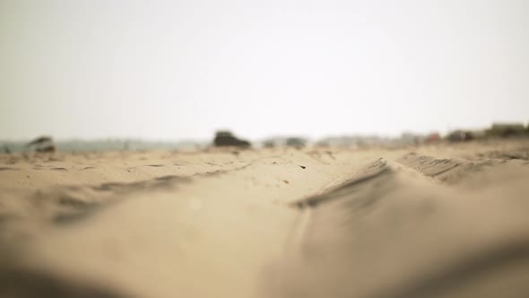 in Slow Motion Perspective View From Ground of Coastal Long Strip of Golden Sand with Camping Tents