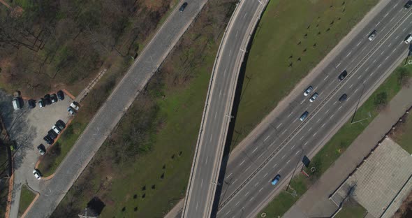 City Traffic on the Bridge and Along the Embankment. Highway Interchange Aerial View