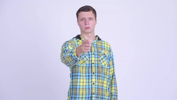 Serious Young Man Looking Angry and Pointing at Camera