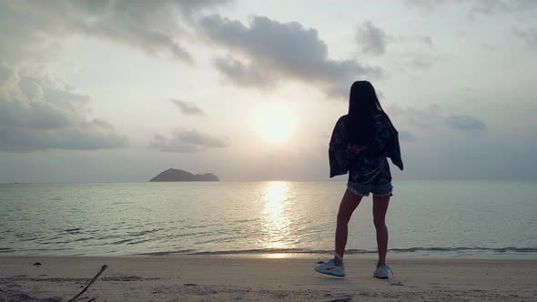 Cute Asian Girl in Kimono Dancing on a Beach at Sunset in Slow Motion Thailand