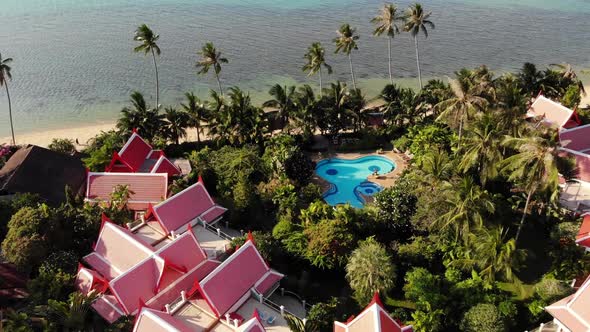 Oriental Houses on Seashore. Drone View of Lovely Oriental Cottages and Green Coconut Palms