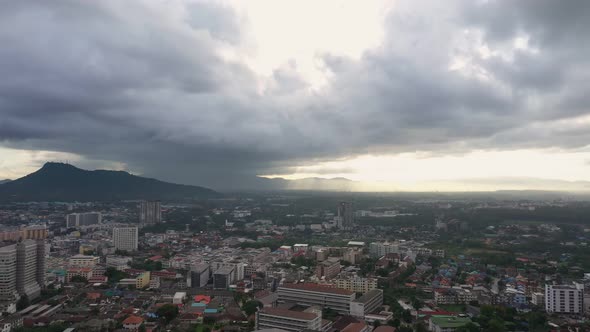 Aerial view drone moving slow motion scene of cityscape with sky sunrise over the mountain.