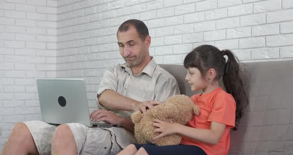 Girl prevents dad from working. 