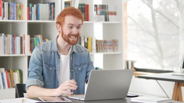 Online Video Chat on Laptop By Casual Redhead Man