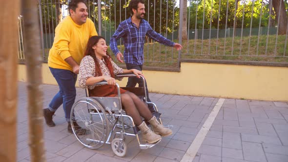 entertain a person with disability - friends quickly push a woman's wheelchair