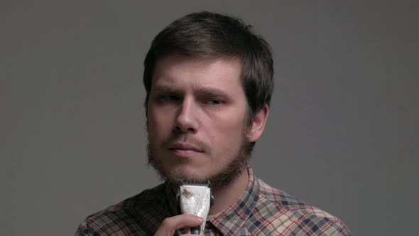 Man Starting to Shave Beard with Razor Machine