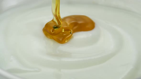 Honey pouring on yogurt, Slow Motion