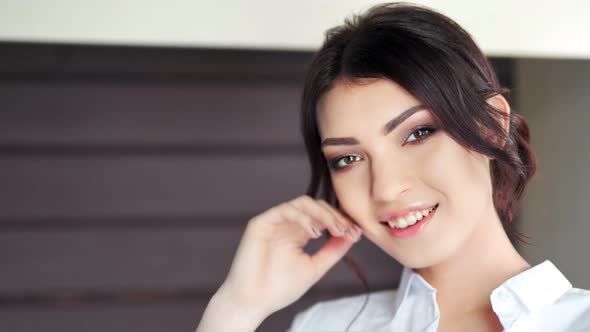 Portrait of Beautiful Sexy Caucasian Girl with Perfect Makeup Smiling and Looking at Camera Closeup