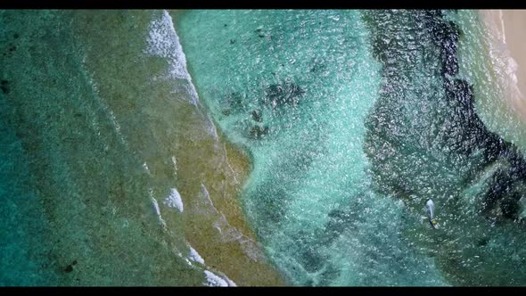 Aerial drone travel of relaxing island beach vacation by blue sea with white sandy background of a p