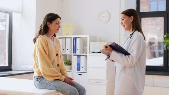 Doctor with Clipboard and Woman at Hospital