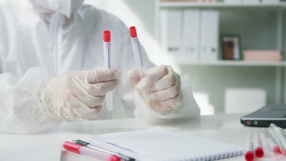 Marking PCR Tests in Laboratory Doctor Writing Results on COVID19 Swab Collection Kit Lab Worker in