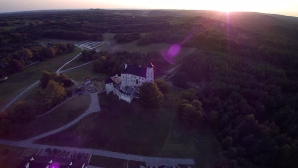 Castle in the forest, sunset, view from a drone 4K