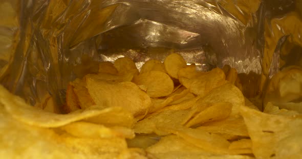 Close Up Craft Fried Golden Potato Chip Inside Package Fast Food Background