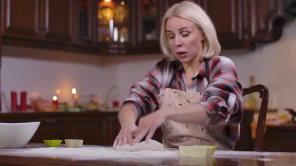 Blond Caucasian Woman Kneading Dough Sneezing Flour Flying Around