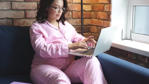 Attractive Pregnant Lady Sit with Laptop and Diary