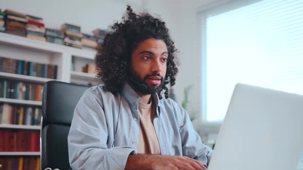 Young Arabian American Man Call Center Employee Speaks Using Headset