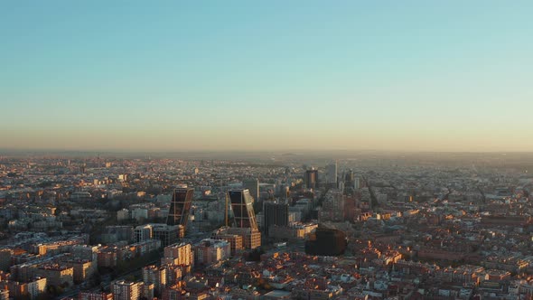 Backwards Descending Footage of Large City in Sunset Time