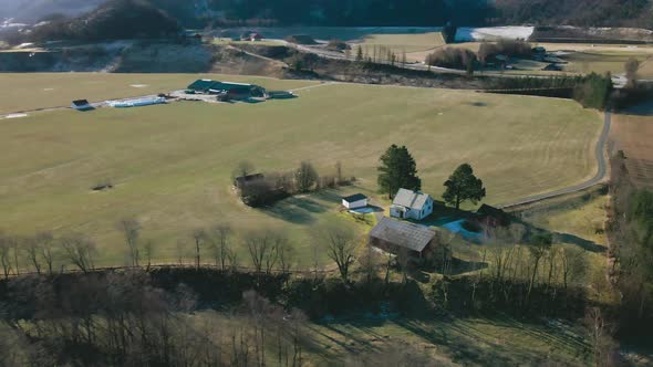 Aerial View Of Vast Field Landscape With Farmhouses. Dairy Farm In Norway.