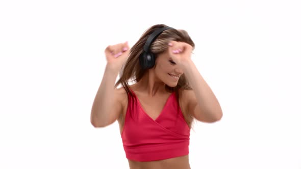 Portrait of Happy Female Listening Music in Headphones Enjoying Dancing