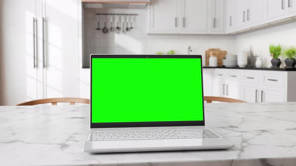 Laptop with Green Screen On Table With Kitchen Backgrounds