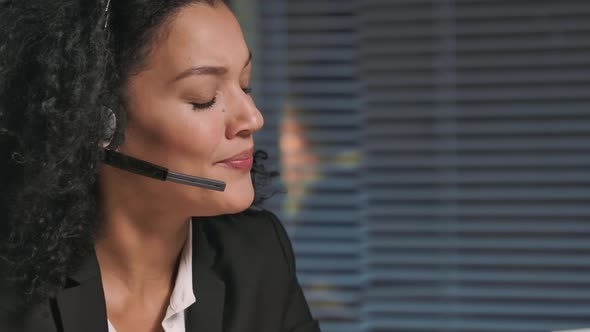 Portrait of African American Woman in Business Suit Talking on Headphones Call Center