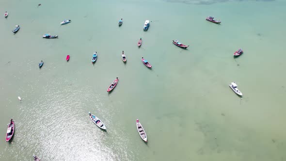 Amazing aerial view of Longtail fishing boats in the tropical sea at Rawai beach Phuket Thailand