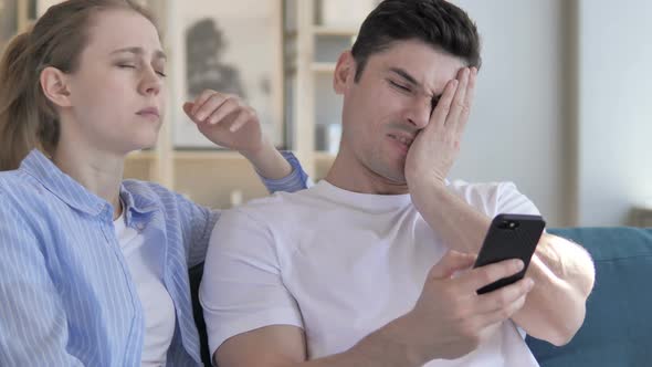 Upset Couple Reacting to Online Loss Smartphone