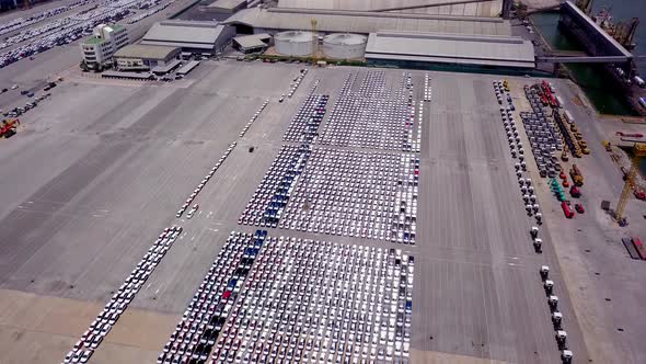 Aerial view of logistics concept of commercial vehicles, cars and pickup trucks waiting to be load o