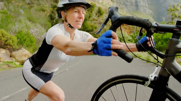 Senior cyclist exercising with cycle at countryside 4k