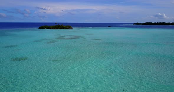 Luxury fly over copy space shot of a sunshine white sandy paradise beach and aqua blue water backgro