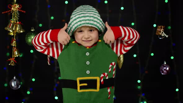 Teen Kid Girl Christmas Elf Santa Claus Helper Costume Showing Thumbs Up Black Background