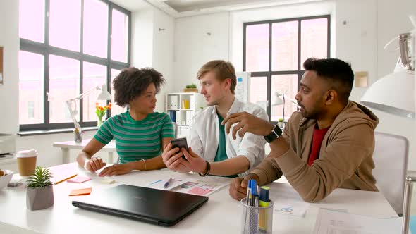 Man Showing Smartphone To Coworkers at Office 83