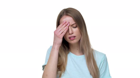 Portrait of Sick Woman with Blond Hair Touching Her Forehead and Feeling Tired or Having Headache