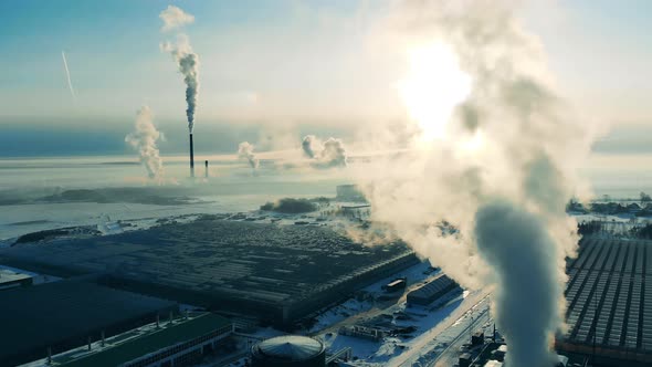 Power Factory From Above, Steam From a Smokestack. Greenhouse Complex with Smoke Coming Out of the